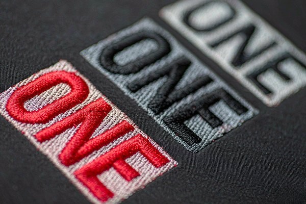 Patch text legibility: embroidered patches showing lettering at different sizes from crisp to filled-in